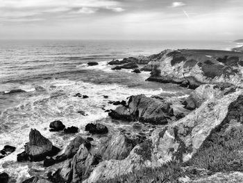 Rocks on beach against sky