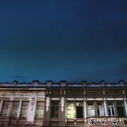 Low angle view of building against blue sky