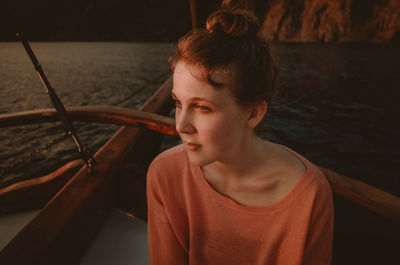 Girl sitting on boat in sea