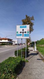 Road sign against blue sky