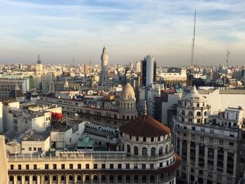 Buildings against cloudy sky