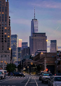 View of city street and buildings against sky