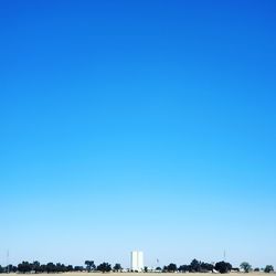 Buildings against clear blue sky