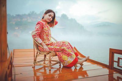 Asian woman wearing cheongsam traditional red dress on chinese new year travel.