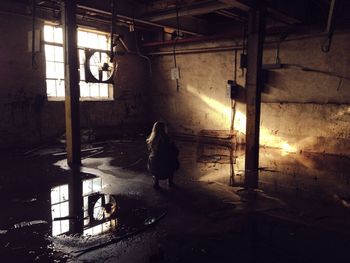 Silhouette of woman against wall