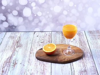 Glass of orange juice on table