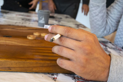 Midsection of man playing leisure game 