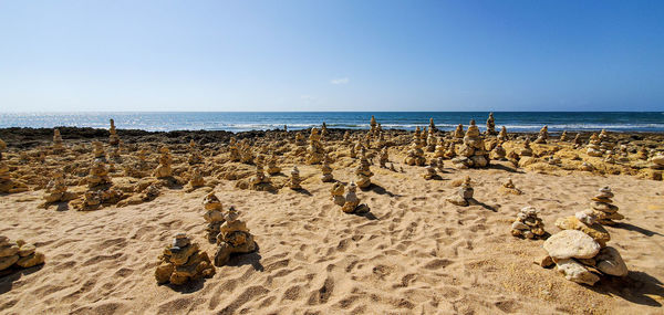 Panoramic view of beach against clear sky