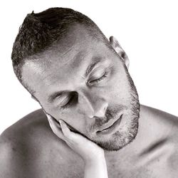 Close-up portrait of young man against white background