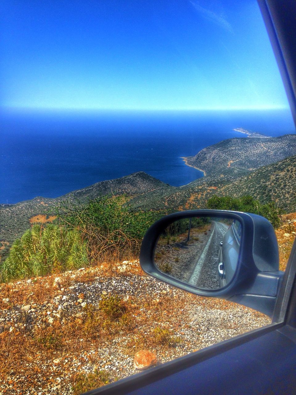 transportation, blue, mode of transport, horizon over water, sea, vehicle interior, clear sky, car, land vehicle, sky, scenics, water, beauty in nature, landscape, transparent, travel, tranquil scene, nature, window, part of