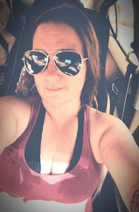 Portrait of woman wearing sunglasses in car