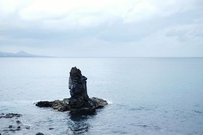 Scenic view of sea against cloudy sky