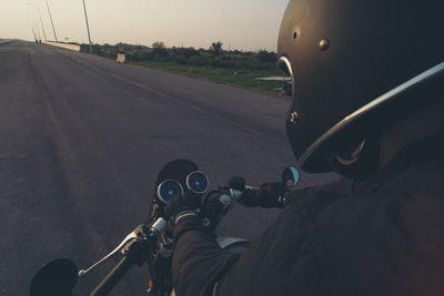 Man riding bicycle on road in city