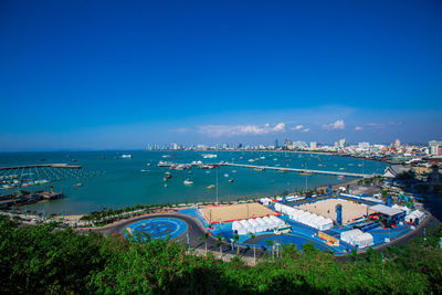 High angle view of swimming pool by sea against blue sky