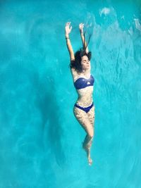 Young woman swimming in pool