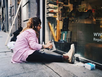 Side view of woman using mobile phone