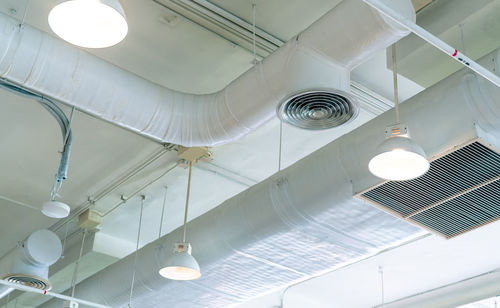 Directly below shot of illuminated pendant lights hanging from ceiling