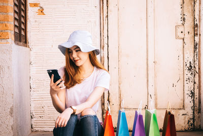Young woman using mobile phone outdoors