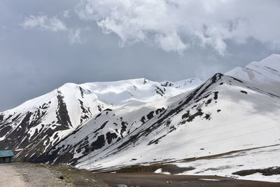 Scenic view of snow covered mountains against sky