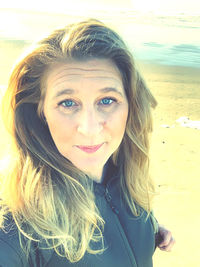 Portrait of smiling young woman on beach