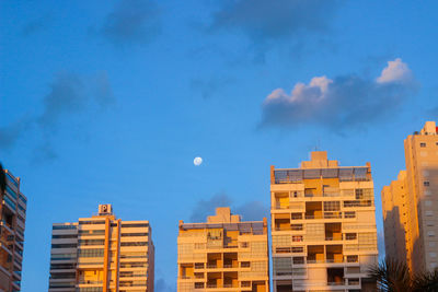 Low angle view of buildings against blue sky