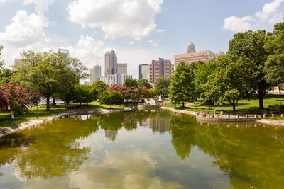 Reflection of trees and buildings in lake