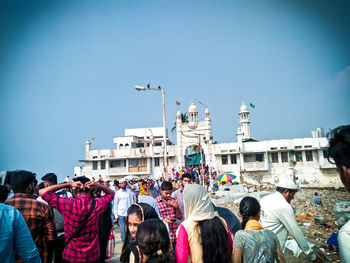 People at town square against clear sky