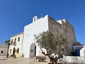 Low angle view of historic building against clear blue sky