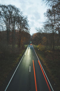 Road amidst trees against sky