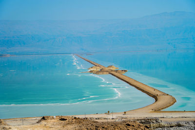 Scenic view of dead sea against blue sky