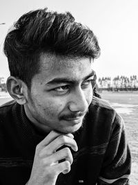 Close-up portrait of young man looking away