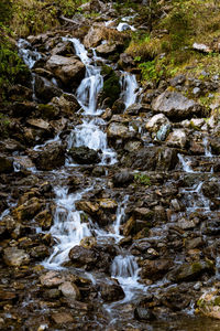 Scenic view of waterfall in stream