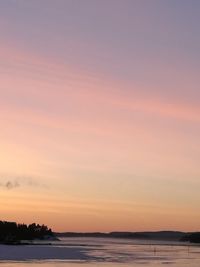 Scenic view of sea against sky at sunset