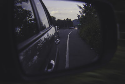 Close-up of car on road