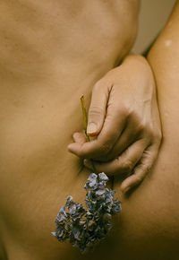 Hand with lilac flower between female body ii