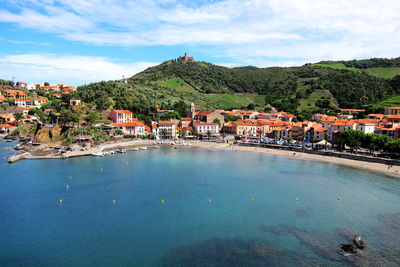 Scenic view of sea and buildings against sky