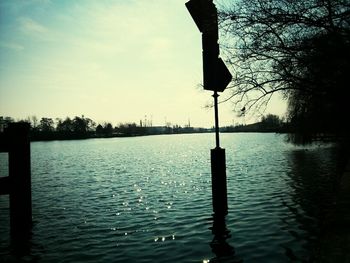 Calm lake with trees in background