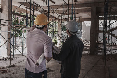 Rear view of man working at construction site