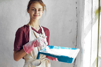 Portrait of young woman holding bag