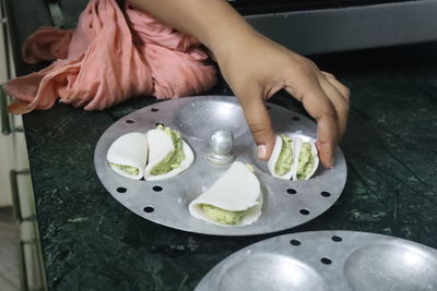 High angle view of woman preparing food on table