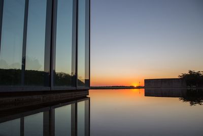 Reflection of museum building in water during sunrise