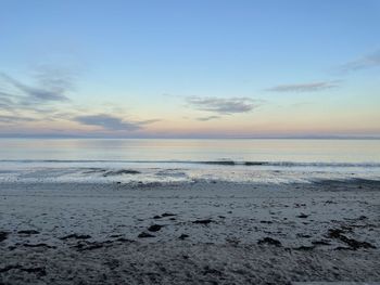 Scenic view of beach against sky during sunset