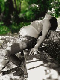 Close-up of woman sitting on tree