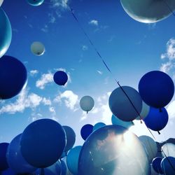 Low angle view of balloons against blue sky