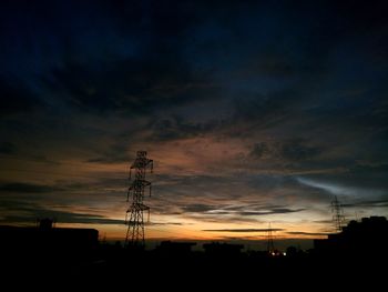 Low angle view of silhouette electricity pylon against sky during sunset