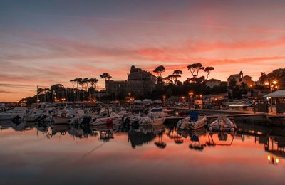 Sailboats in marina during sunset