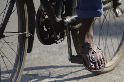 Low section of man riding bicycle on street