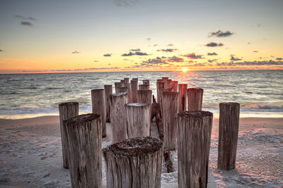 Dilapidated ruins of a pier on port royal beach at sunset in naples, florida