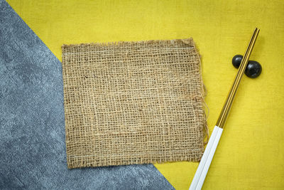 High angle view of yellow paint on table