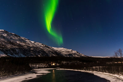 Scenic view of illuminated mountains against clear sky at night